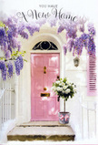 This photograph offers a gentle, romantic glimpse of a Lambeth entranceway, as if caught just after a florist has delivered a special new-home surprise. A soft pink front door provides the central focus, its pastel shade muted enough to feel timeless while still radiating friendliness. The panels of the door are subtly highlighted by the natural light, which also reflects off the surrounding whitewashed walls, keeping the entire composition bright yet soothing. Draped over the top of the doorway, wisteria tumbles down in lush curtains of lavender and lilac blooms. Each cluster of flowers hangs like a tassel, layered and delicate, suggesting a sweet fragrance that might drift down into the street - something you could easily imagine near the quieter residential pockets of Lambeth, not far from Clapham North or the hidden gardens off Brixton Road. At the doorstep, a pale grey metal bucket rests with casual grace, angled slightly as if just set down. The bucket brims with an abundant mix of white and cream roses, their petals plush and velvety, each bloom pressed softly against its neighbour. Sprigs of fresh green foliage weave among the roses, breaking up the creamy tones with hints of verdant life and giving the arrangement an airy feeling rather than something too formal. Tied around the bucket is a satin ribbon in gentle pink, finished in a neat bow that echoes the colour of the front door and pulls the whole palette together. A warm, golden light filters across the scene, creating soft shadows beneath the flowers and along the step, lending a sense of depth and intimacy. The overall impression is of a quiet, heartfelt celebration of a new home in Lambeth - a doorway dressed with wisteria and roses that seems to whisper wishes of comfort, luck, and many happy returns through that pink door.